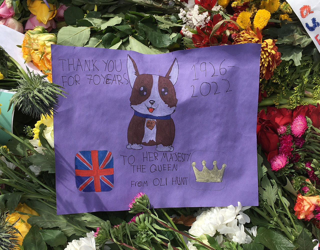 The flowers and pictures left in tribute to Her Majesty The Queen