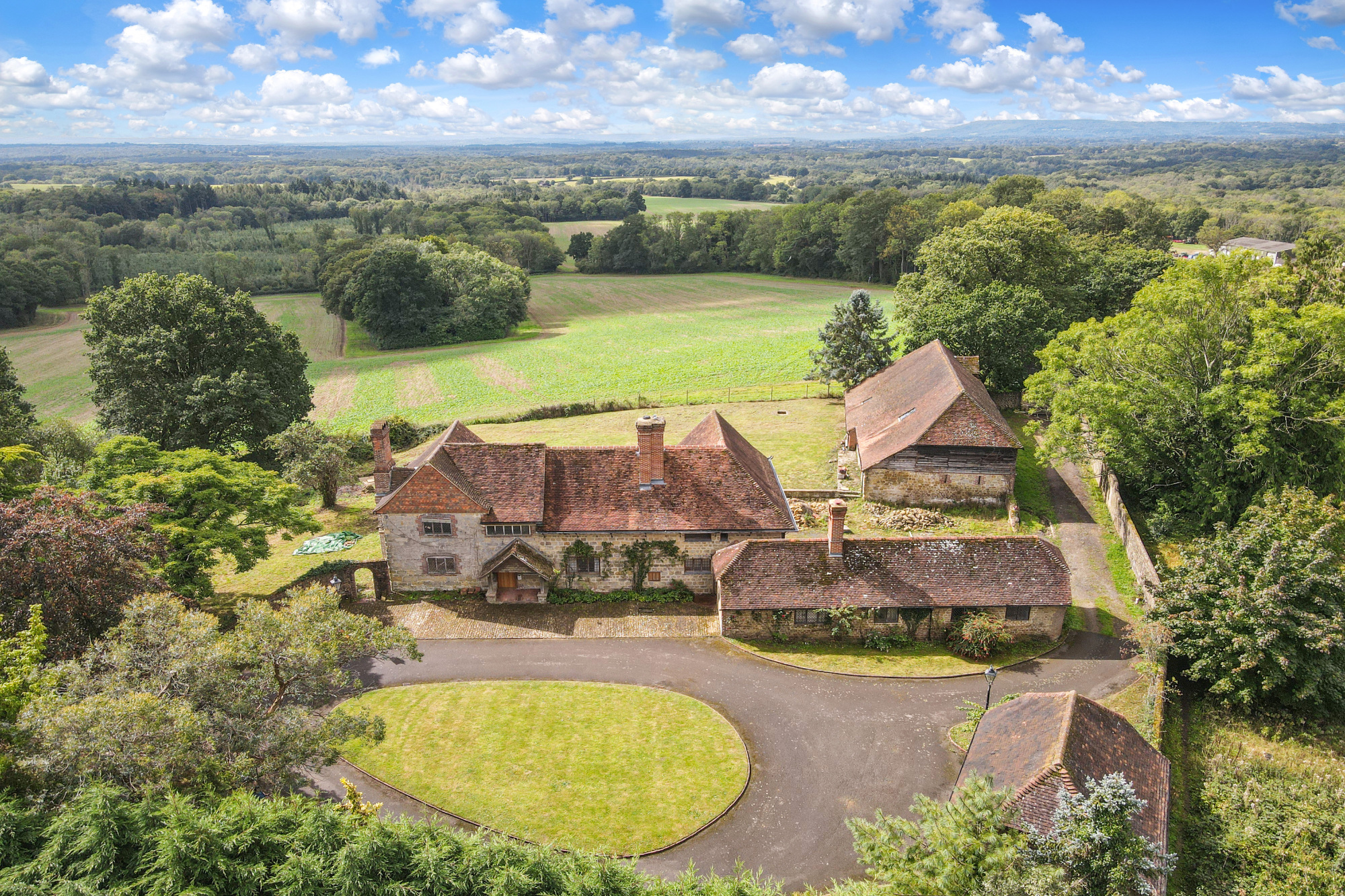 A 16th-century farmhouse in rural Surrey that comes with a thriving 483-acre estate