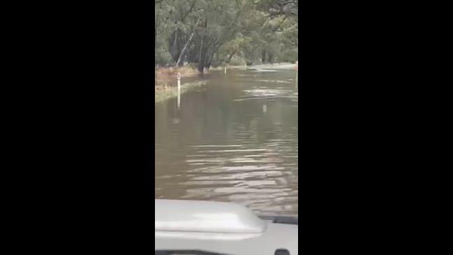 A car drives through flooded roads just south of Bendigo