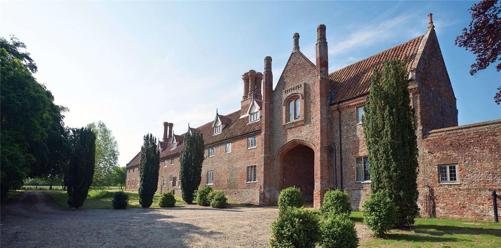 A glorious medieval hall in Norfolk with England’s largest brick-built Tudor barn, a moat, and nine acres